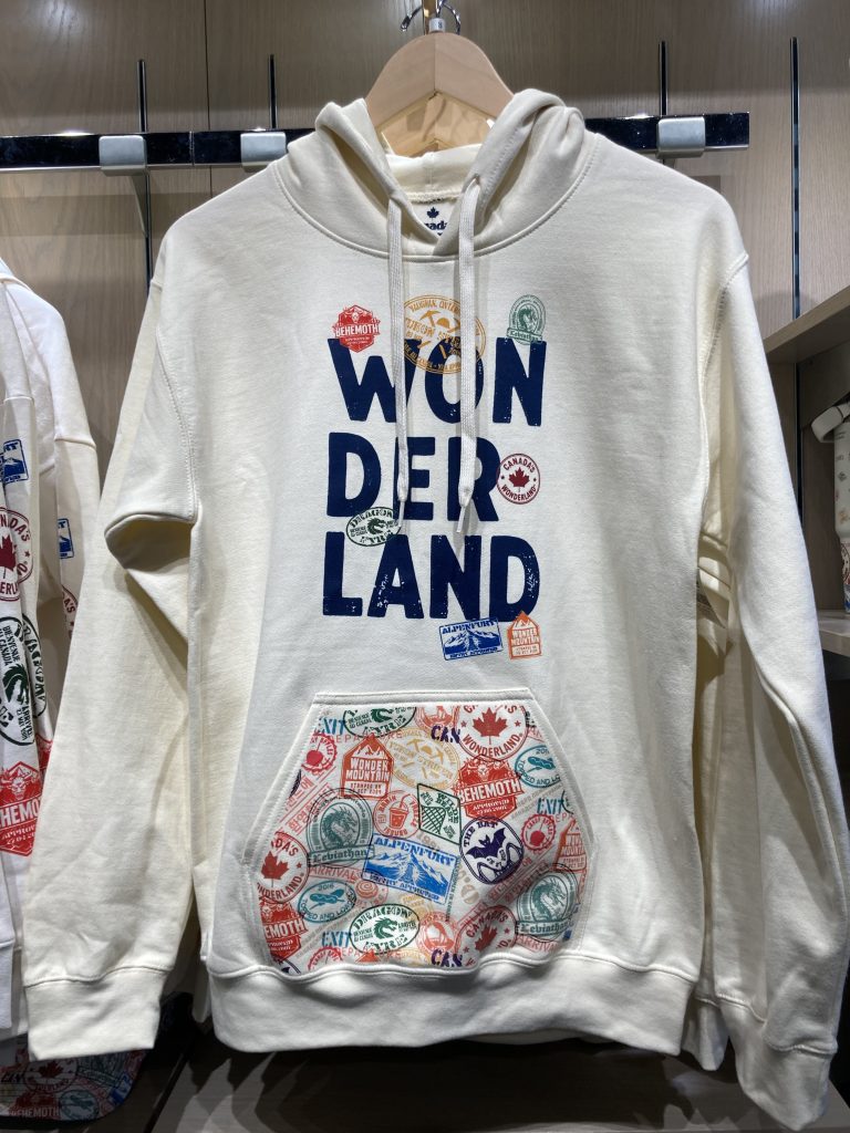 Hoodie with bold WON DER LAND text and various stamp-like graphics.
