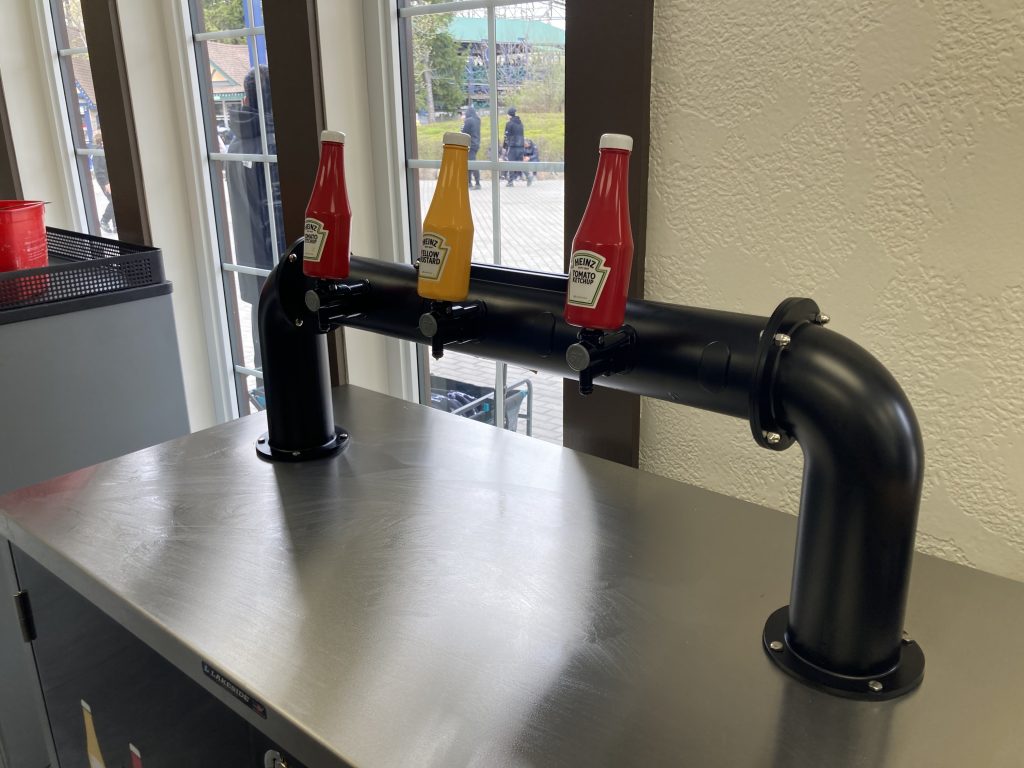 Ketchup and mustard dispensers, shaped like ketchup and mustard bottles.