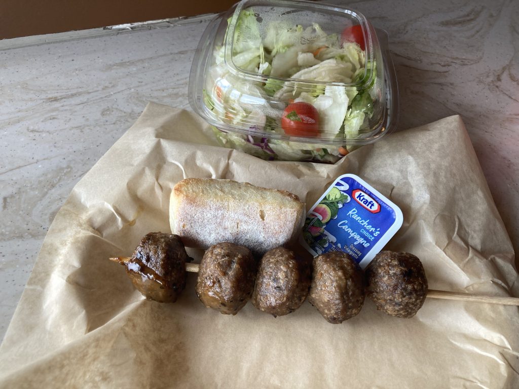 Veggie meatballs and salad, with a ciabatta bun.