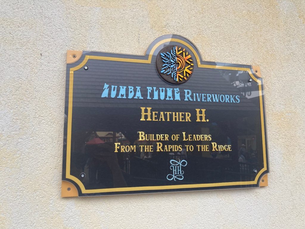 Plaque reading "Zumba Flume Riverworks / Heather H. / Builder of Leaders / From the Rapids to the Ridge"