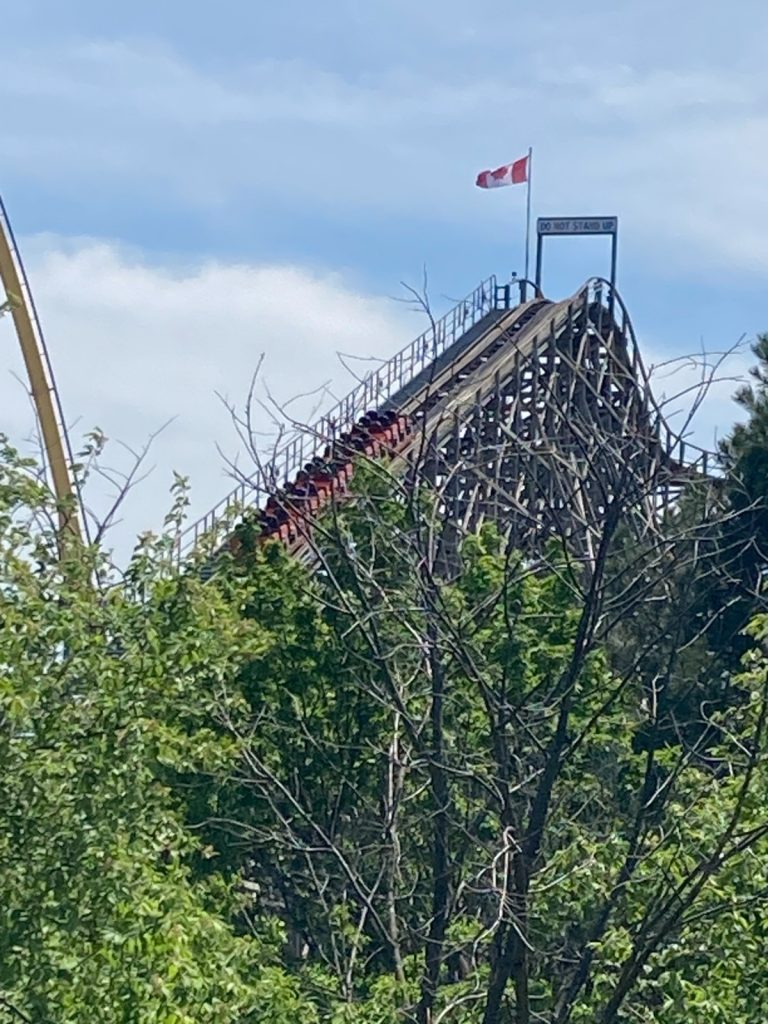 Minebuster's orange train on the lift hill.