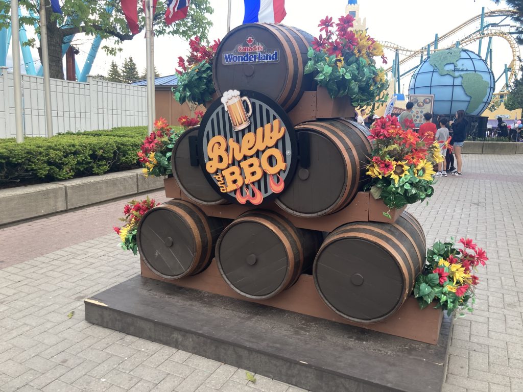 Brew & BBQ entrance sign with barrels.
