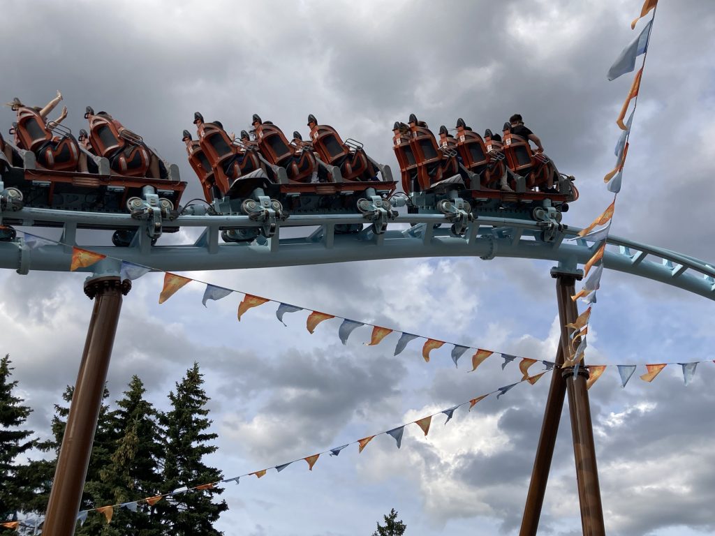 AlpenFest flags, with AlpenFury zooming overhead.