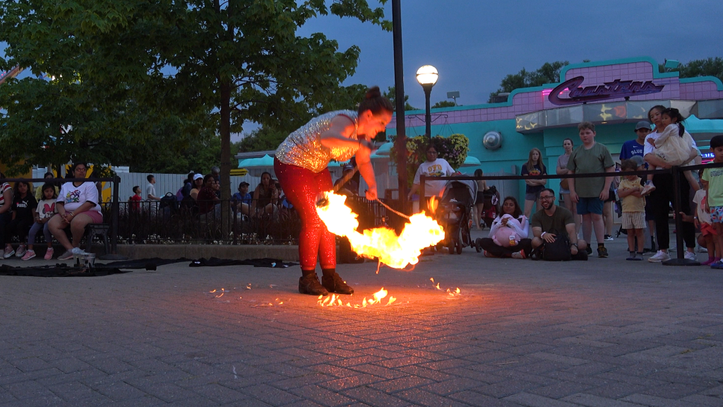 Scarlet lights a circle of fire on the pavers.