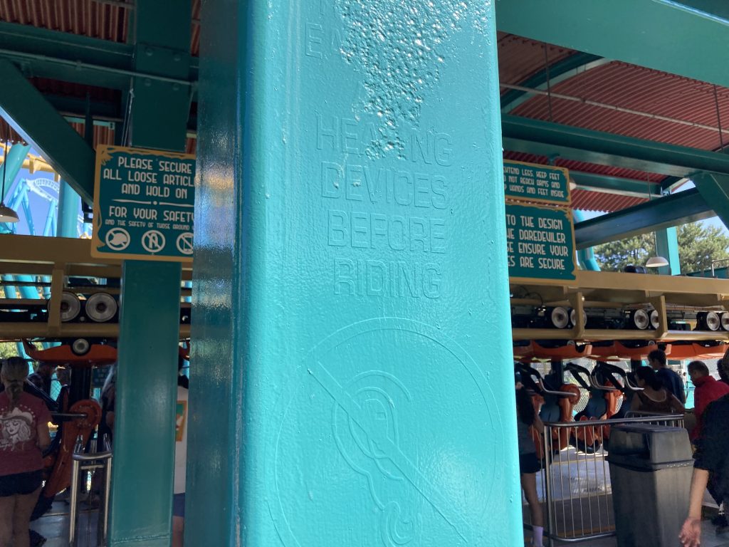 Former instructions on a post, painted over.