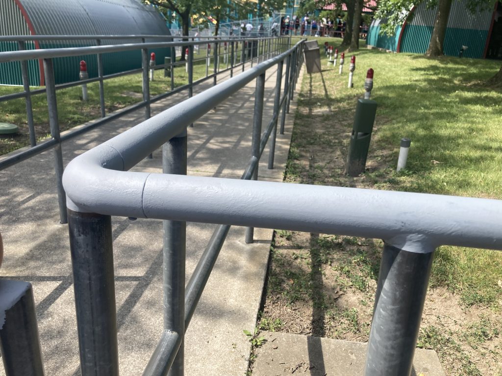 Regular queue railings painted grey on top.
