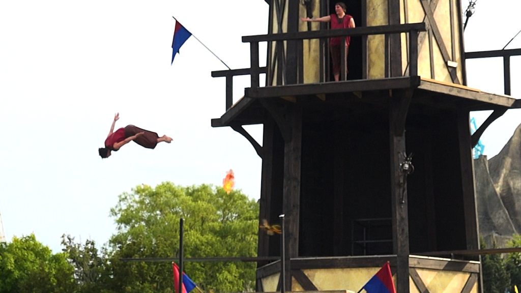 AlpenFury's flame cannon in the background as a diver plummets from the Arthur's Baye structure.