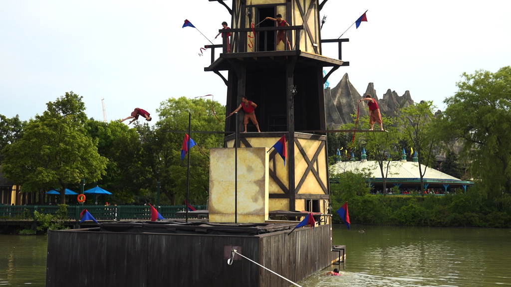The Arthur's Baye performers twirling ribbons as one diver plummets.