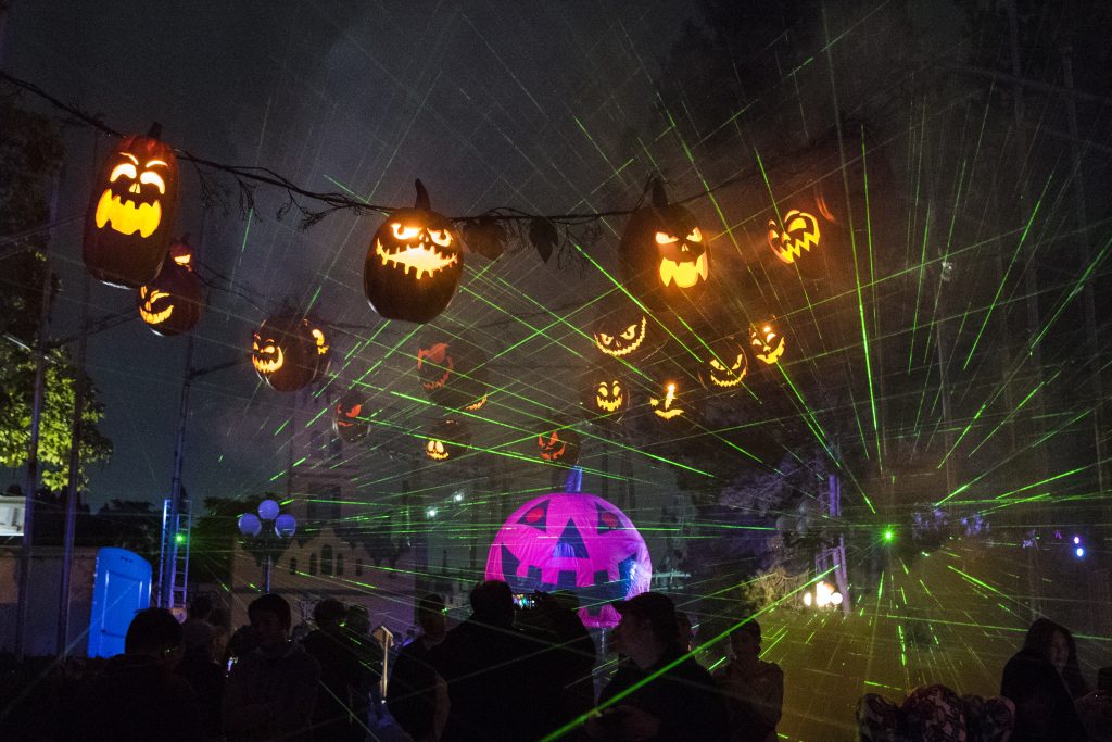 Pumpkins overhead, with lasers in the fog at Halloween Haunt.