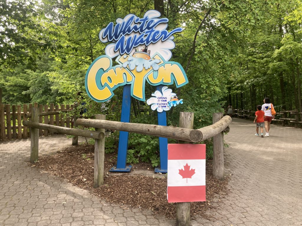 White Water Canyon's entrance with a vertaical Canada flag covering the fireworks early closure sign.
