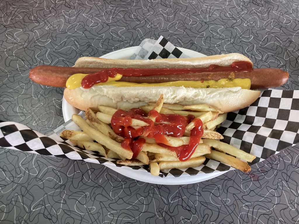 Foot long hot dog with fries.