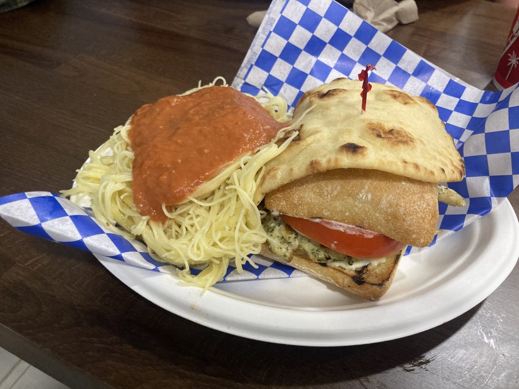 Pasta and a pesto chicken caprese sandwich.