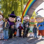 The Peanuts gang in their Halloween costumes, standing on the rainbow bridge.